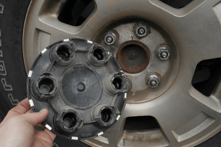 Once the lugs on the cap are removed, the cap comes off, exposing the actual lug nuts.