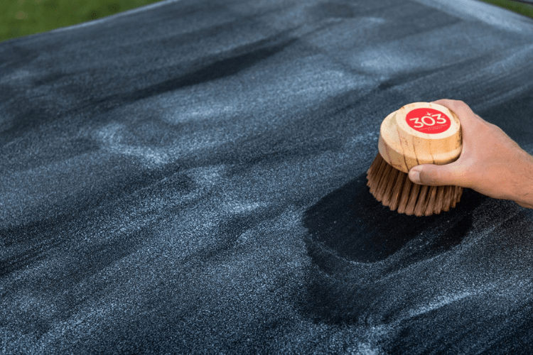 After applying 303 Convertible Top Cleaner, lightly rub it in with a brush, like the 303 Convertible Top Brush.